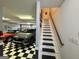 The garage features two cars, checkered flooring, and a convenient staircase leading to other parts of the house at 382 Knox Chapel Rd, Social Circle, GA 30025