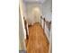 Hallway with wood flooring and white railings, leading to various rooms in the house at 382 Knox Chapel Rd, Social Circle, GA 30025