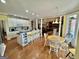 Bright kitchen featuring white cabinets and an island with bar stool seating, flowing into living spaces at 382 Knox Chapel Rd, Social Circle, GA 30025