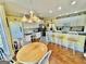 Bright eat-in kitchen featuring white cabinets and countertops, stainless appliances, and a breakfast bar at 382 Knox Chapel Rd, Social Circle, GA 30025