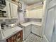 Functional laundry room with washer, dryer, white cabinets, and tiled flooring at 382 Knox Chapel Rd, Social Circle, GA 30025