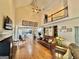 Open concept living room featuring vaulted ceilings, a fireplace, and views into the kitchen at 382 Knox Chapel Rd, Social Circle, GA 30025