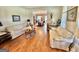 Cozy living room with hardwood floors, floral sofas, and a view into the adjacent dining room at 382 Knox Chapel Rd, Social Circle, GA 30025