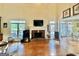 Spacious living room featuring a brick fireplace, large windows, and access to the eat-in kitchen at 382 Knox Chapel Rd, Social Circle, GA 30025