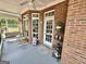 Covered porch with outdoor decor, providing a sheltered space for enjoying the surrounding views at 382 Knox Chapel Rd, Social Circle, GA 30025