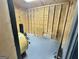 Unfinished storage room with wood frame walls and fan, ready for customization at 382 Knox Chapel Rd, Social Circle, GA 30025
