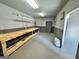 Workshop with gray walls and floor, featuring a large wooden workbench along one wall at 382 Knox Chapel Rd, Social Circle, GA 30025