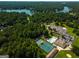 A high angle aerial view shows the pool and tennis courts near a lake at 3180 Sweetbriar Dr, Villa Rica, GA 30180