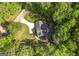 Overhead perspective of house showing its location amidst lush greenery and a private driveway at 3180 Sweetbriar Dr, Villa Rica, GA 30180