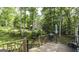 Relaxing outdoor space with deck, grill, and a view of the wooded backyard at 3180 Sweetbriar Dr, Villa Rica, GA 30180