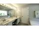 Bathroom features a double vanity with a soaking tub and large mirror at 3180 Sweetbriar Dr, Villa Rica, GA 30180