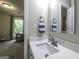Modern bathroom with a white marble countertop, a mirror, and a view of the living room at 3180 Sweetbriar Dr, Villa Rica, GA 30180