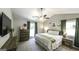 Primary bedroom with a vaulted ceiling, ceiling fan, and dark green curtains at 3180 Sweetbriar Dr, Villa Rica, GA 30180