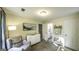 Bedroom features an accent chair, white dresser, and a view of the en suite bathroom at 3180 Sweetbriar Dr, Villa Rica, GA 30180