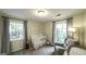 Bright Bedroom with two windows, a crib, and an accent chair with blanket at 3180 Sweetbriar Dr, Villa Rica, GA 30180