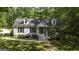 Charming home with stone accents, landscaped yard, and inviting front porch at 3180 Sweetbriar Dr, Villa Rica, GA 30180