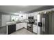 Bright kitchen featuring stainless steel appliances, granite countertops, and white cabinetry at 3180 Sweetbriar Dr, Villa Rica, GA 30180