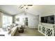 Spacious living room featuring a comfortable sofa, vaulted ceiling, and modern decor at 3180 Sweetbriar Dr, Villa Rica, GA 30180
