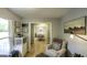 Living area with open view to dining room, hardwood flooring, and natural light at 3180 Sweetbriar Dr, Villa Rica, GA 30180