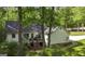 Features a spacious back deck, with steps down to the yard, surrounded by trees at 3180 Sweetbriar Dr, Villa Rica, GA 30180