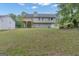 Large backyard with lush lawn, trees, and view of the home's deck and exterior at 1341 Huey Rd, Douglasville, GA 30134