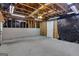 Unfinished basement featuring concrete flooring, exposed framing, and utilities at 1341 Huey Rd, Douglasville, GA 30134