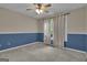 This bedroom features wainscotting, carpet floors, and a ceiling fan at 1341 Huey Rd, Douglasville, GA 30134