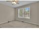 This bedroom features neutral paint, a ceiling fan, and a window at 1341 Huey Rd, Douglasville, GA 30134