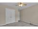 This bedroom features neutral paint, a ceiling fan, and a closet at 1341 Huey Rd, Douglasville, GA 30134