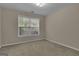 This bedroom features neutral paint and a window at 1341 Huey Rd, Douglasville, GA 30134
