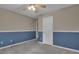 This bedroom features neutral paint, a ceiling fan, and baseboard trim at 1341 Huey Rd, Douglasville, GA 30134