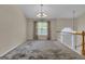 Open dining room with hanging chandeliers, near the stairs at 1341 Huey Rd, Douglasville, GA 30134