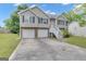Charming two-story home featuring a two-car garage, landscaped yard, and inviting front entrance at 1341 Huey Rd, Douglasville, GA 30134