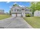 Charming two-story home featuring a two-car garage, landscaped yard, and inviting front entrance at 1341 Huey Rd, Douglasville, GA 30134