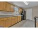 Practical kitchen featuring standard appliances, wooden cabinets, and ample countertop space at 1341 Huey Rd, Douglasville, GA 30134