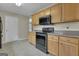 Clean kitchen with wooden cabinets, granite countertops and black appliances at 1341 Huey Rd, Douglasville, GA 30134