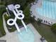 Aerial view featuring a waterslide and pool, creating an exciting recreation area for residents at 1141 Pebble Creek Ln, Locust Grove, GA 30248