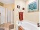 Relaxing bathroom with a soaking tub, towel rack, and elegant artwork enhancing the spa-like atmosphere at 1141 Pebble Creek Ln, Locust Grove, GA 30248