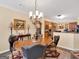 Formal dining room featuring a chandelier, hardwood table, and decorative wall art at 1141 Pebble Creek Ln, Locust Grove, GA 30248