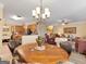 Chandelier lit dining room showcasing a wood table, and decor at 1141 Pebble Creek Ln, Locust Grove, GA 30248