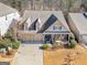 Charming home with a three-car garage, dormers, front porch, and beautiful landscaping at 1141 Pebble Creek Ln, Locust Grove, GA 30248