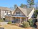 Attractive home with stone details, a welcoming front porch, and lush landscaping in the front yard at 1141 Pebble Creek Ln, Locust Grove, GA 30248