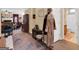Cozy hallway featuring a coat rack, decorative rug, and views into the living area and bathroom at 1141 Pebble Creek Ln, Locust Grove, GA 30248