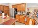 This well-organized kitchen features wood cabinets, stainless steel appliances, and stone countertops at 1141 Pebble Creek Ln, Locust Grove, GA 30248