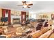 Spacious living room with a fireplace, ceiling fan, ample seating and neutral tones at 1141 Pebble Creek Ln, Locust Grove, GA 30248