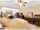 Comfortable main bedroom featuring a ceiling fan, warm colors, and sitting area at 1141 Pebble Creek Ln, Locust Grove, GA 30248