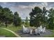 Inviting outdoor fire pit area surrounded by Adirondack chairs, perfect for relaxing gatherings at 1141 Pebble Creek Ln, Locust Grove, GA 30248