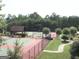 Well-maintained community tennis courts surrounded by lush greenery, offering a perfect space for sports and recreation at 1141 Pebble Creek Ln, Locust Grove, GA 30248
