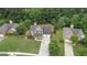 An aerial view of a two-story home with a manicured lawn and mature trees surrounding the property at 243 Kensington Trce, Stockbridge, GA 30281