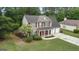 An aerial view of a two-story home with a manicured lawn and mature trees surrounding the property at 243 Kensington Trce, Stockbridge, GA 30281